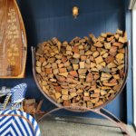 Steel U-shaped log rack filled with chopped fire wood.