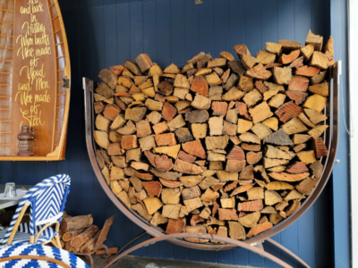 Steel U-shaped log rack filled with chopped fire wood.