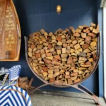 Steel U-shaped log rack filled with chopped fire wood.