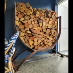 Steel U-shaped log rack filled with chopped fire wood.